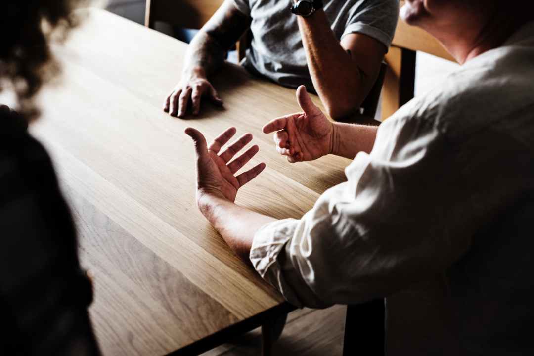 people sitting in front of wooden table