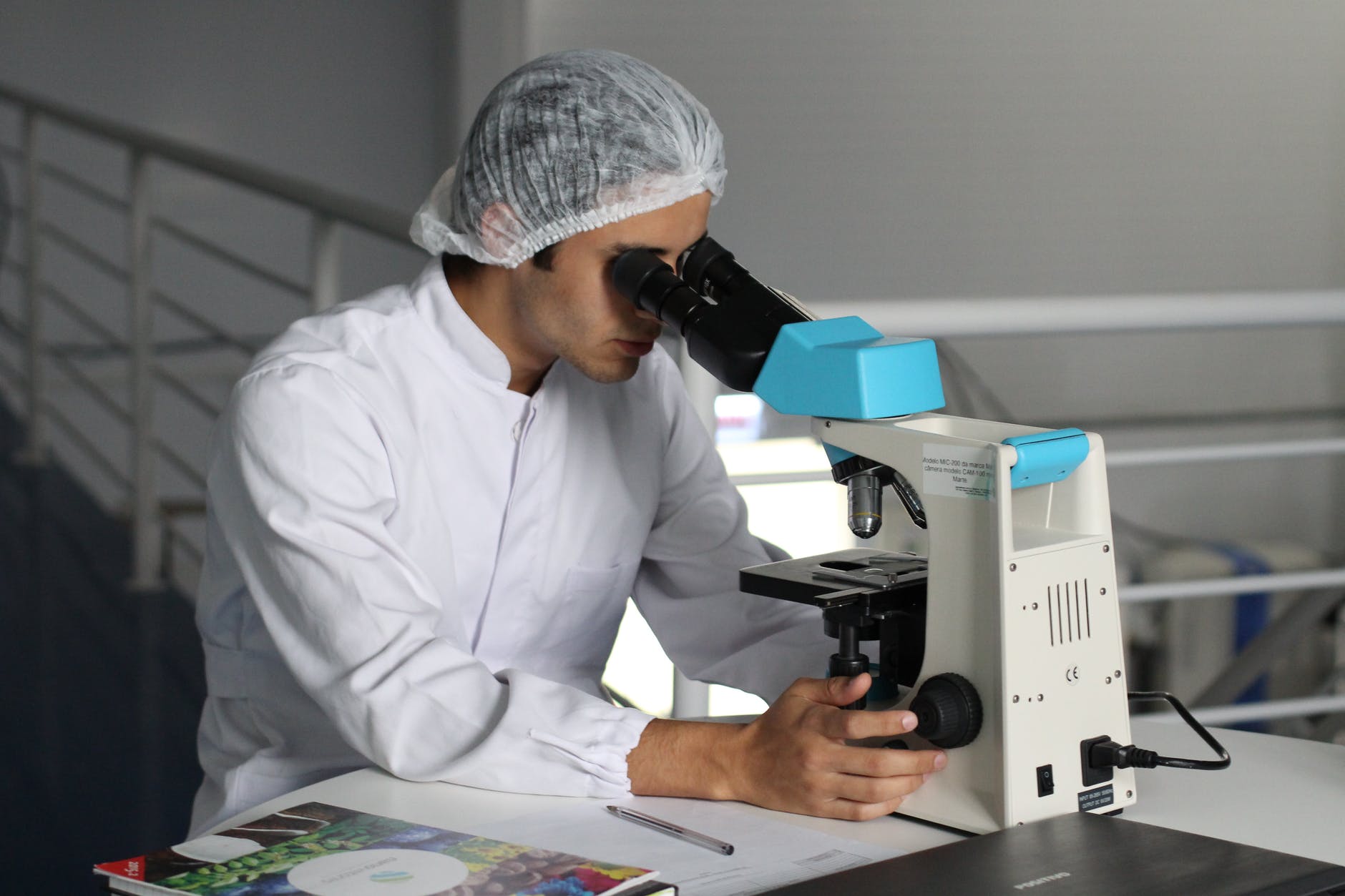 Medical Student looking through a microscope